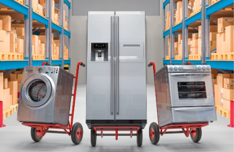 Washer, refrigerator and stove on hand trucks in a warehouse ready for delivery